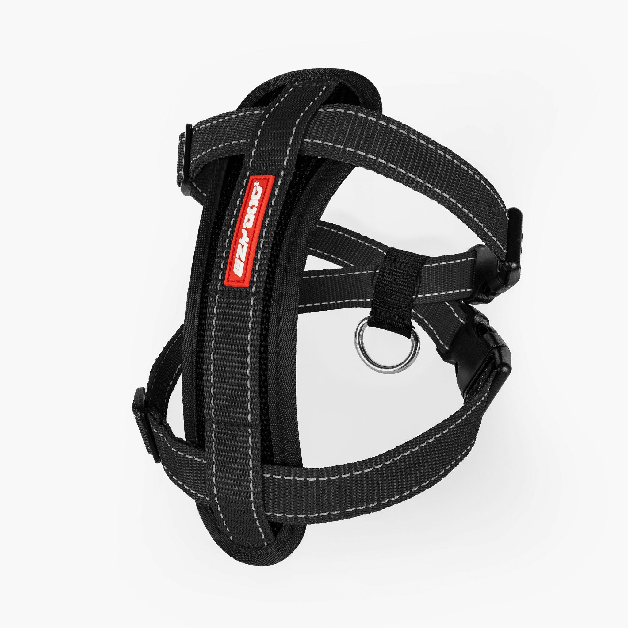 A black chest plate harness for dogs with adjustable straps and reflective stitching, including a metal ring for leash attachment.