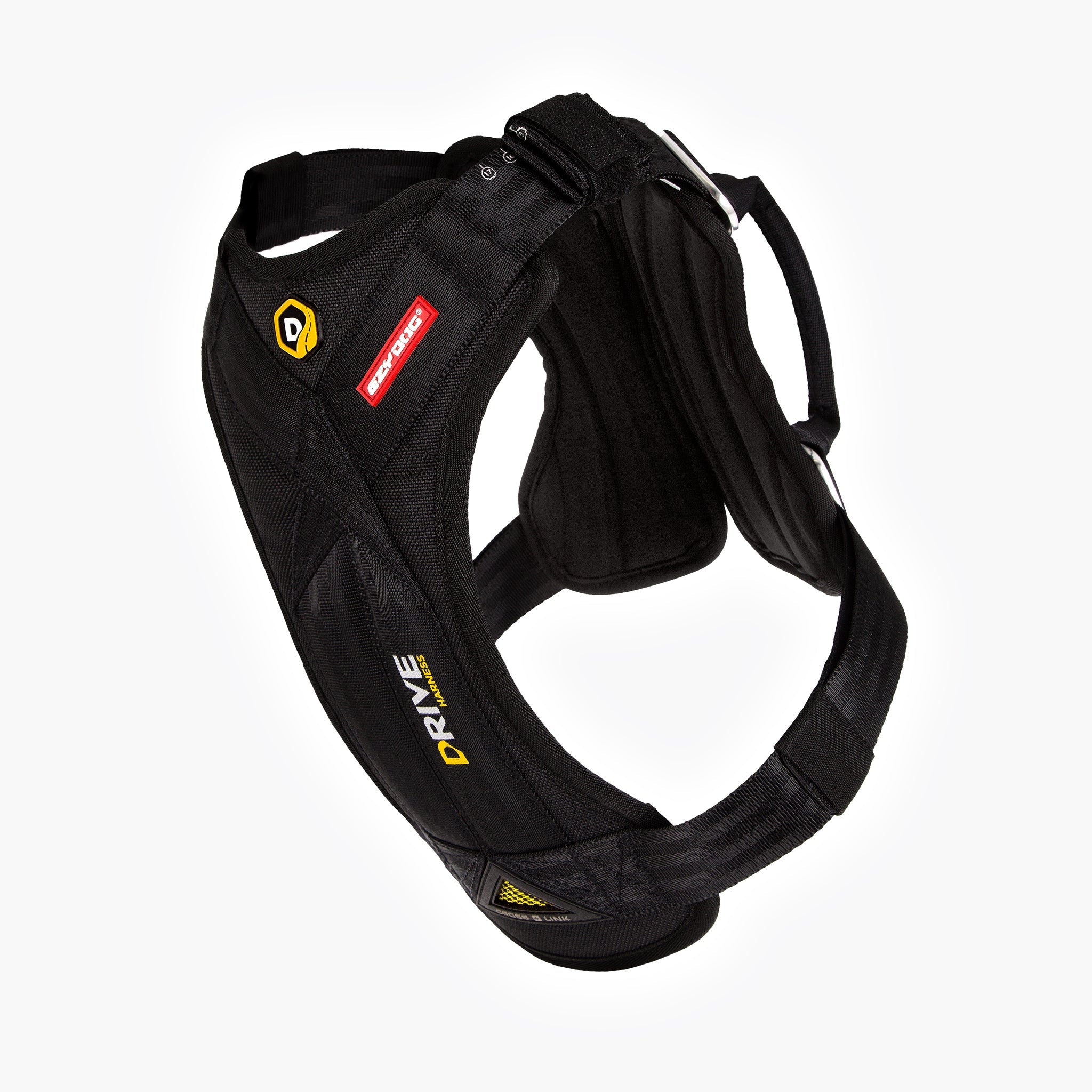 A black drive dog car harness with webbing handles and a buckle, featuring double stainless steel D-rings and a padded chest plate.