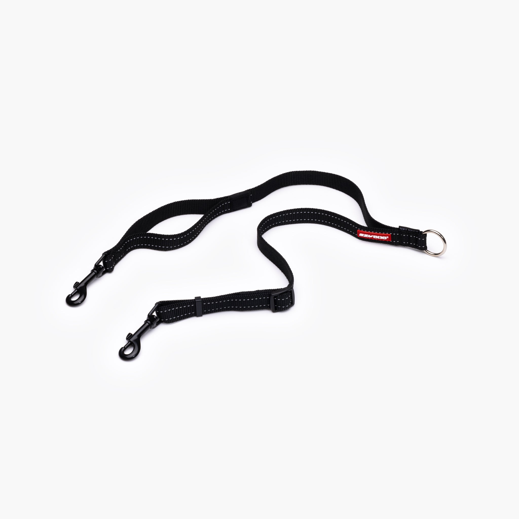 A black EzyDog Soft Touch Coupler for walking two dogs, featuring adjustable straps and traffic control handle.