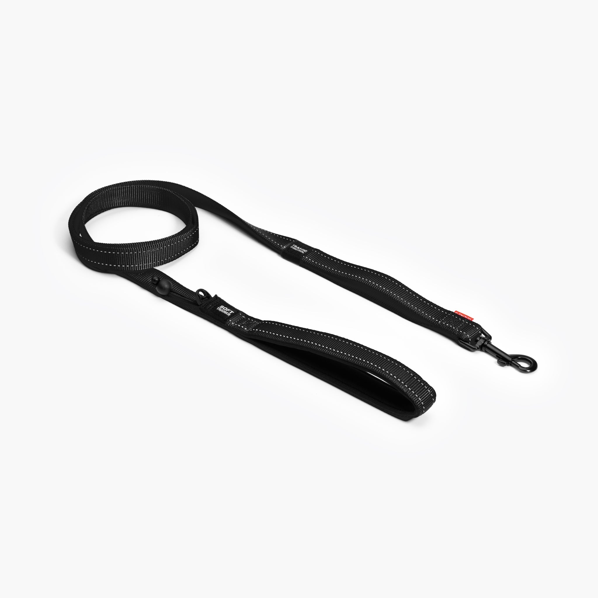 A black EzyDog Soft Trainer Dog Lead with reflective trim, neoprene-lined handle, and barrel lock for waste bags.